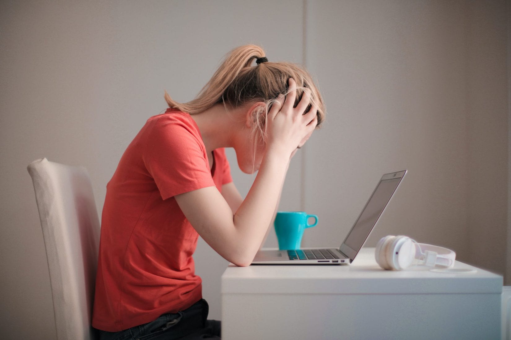 Woman stressed in front of laptop