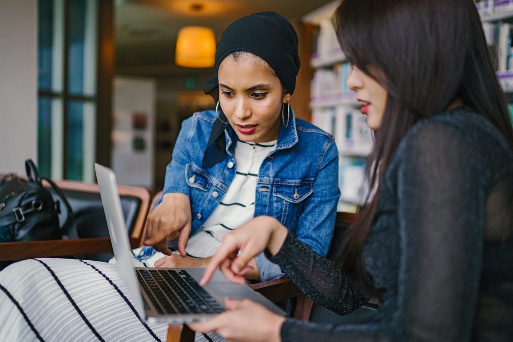 Two women looking at laptop