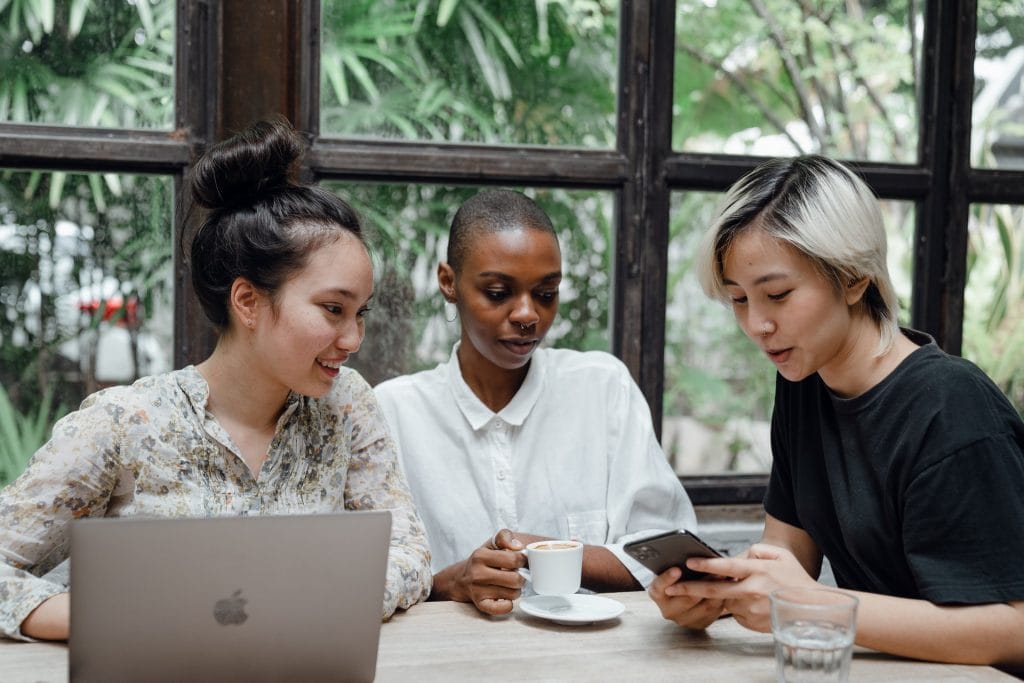 Woman showing phone to friends 