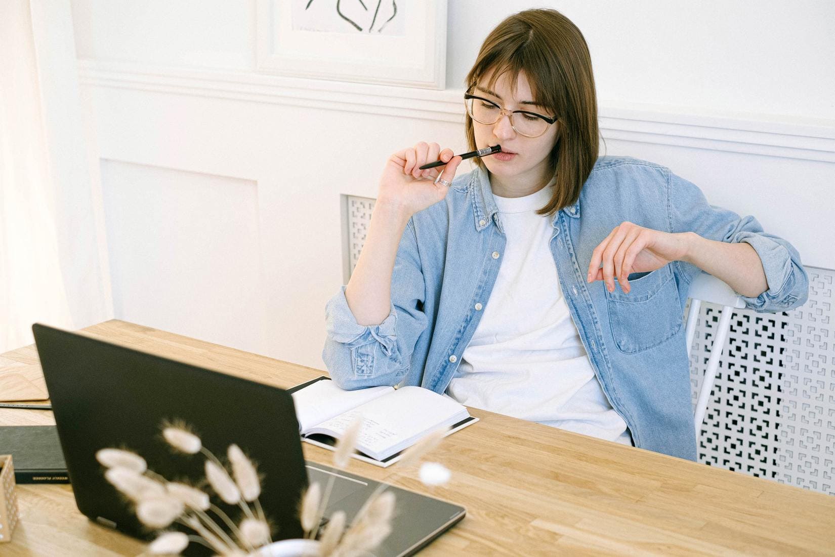 Girl thinking in front of laptop