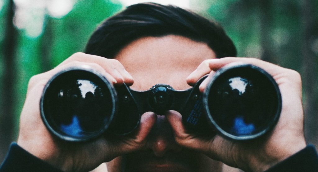 man using binoculars