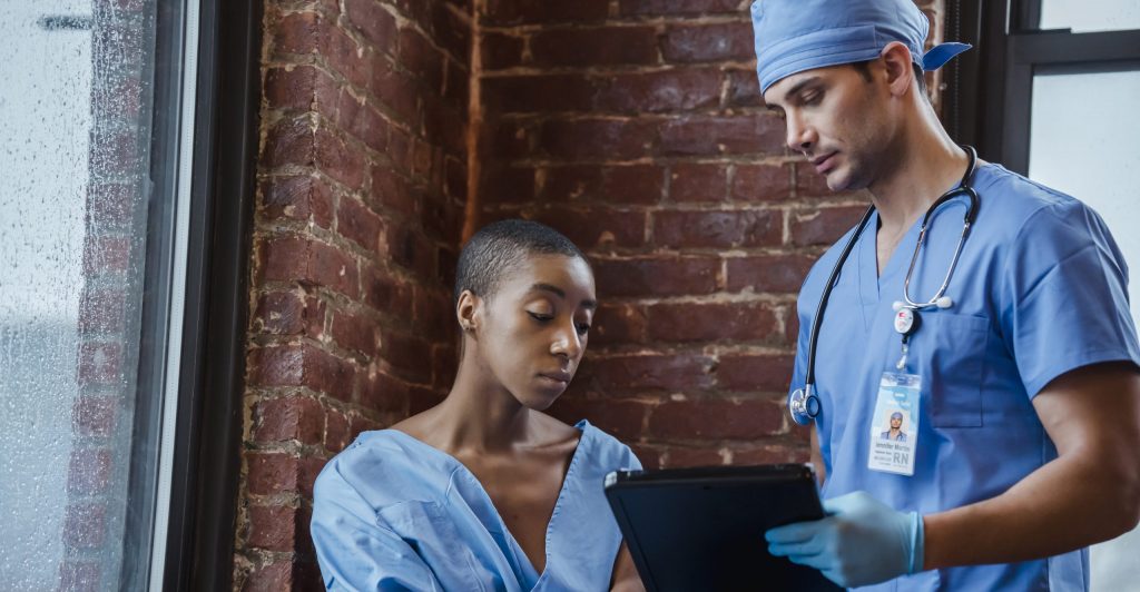 Doctor showing diagnosis to black patient in hospital