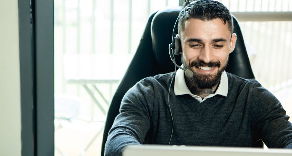 Man in black sweater wearing black headphones