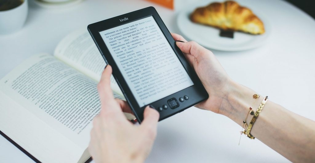 Person holding kindle e book reader