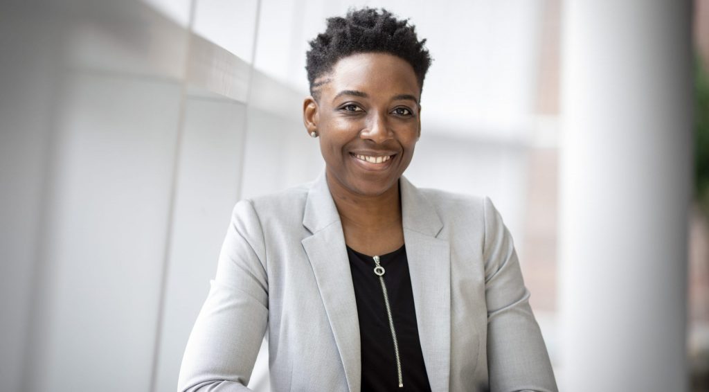 Woman wearing gray notch lapel suit jacket