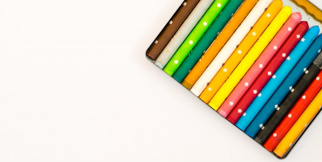 Multi colored pencils over white background