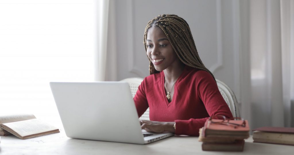 Woman in red long sleeve shirt using macbook air