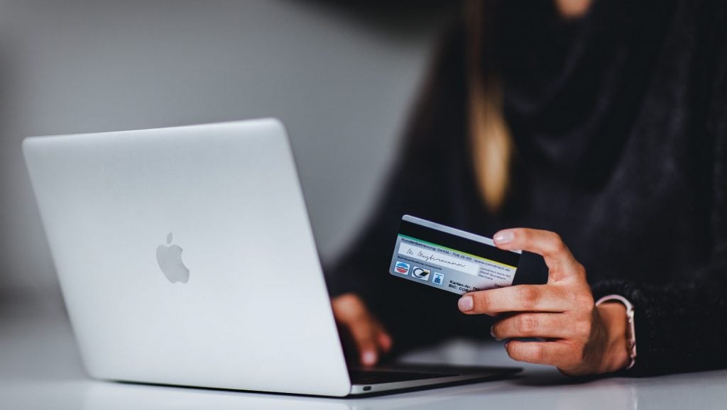 A woman who enters her bank details while shopping online.