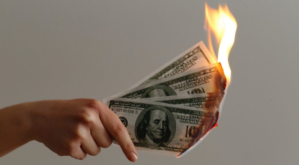 burned 100 US dollar banknotes